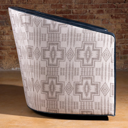 Profile view of the Silver Mesa Swivel Chair with navy top-grain leather seat and Pendleton fabric sides