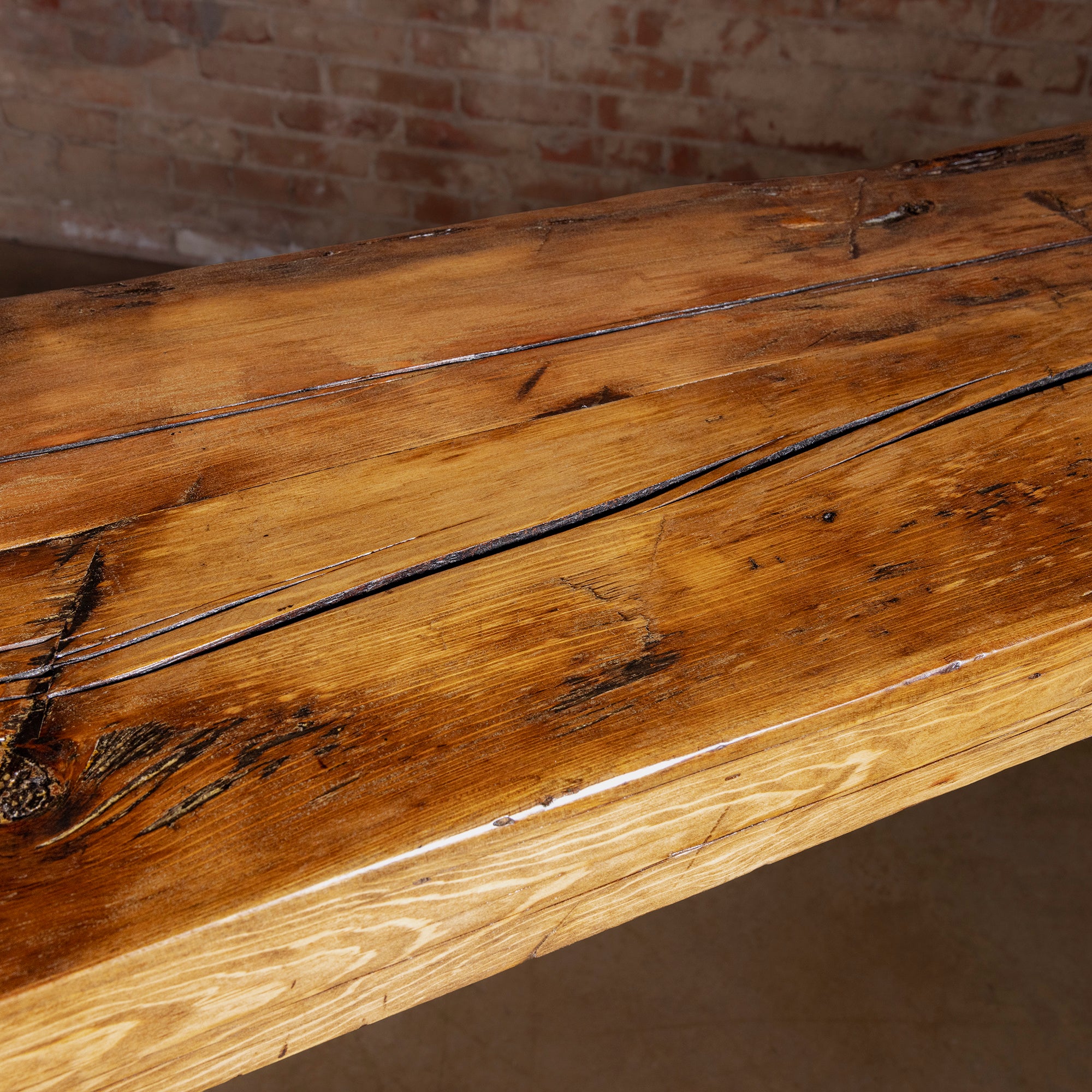 Closeup of reclaimed wood console tabletop showing knots and grain character
