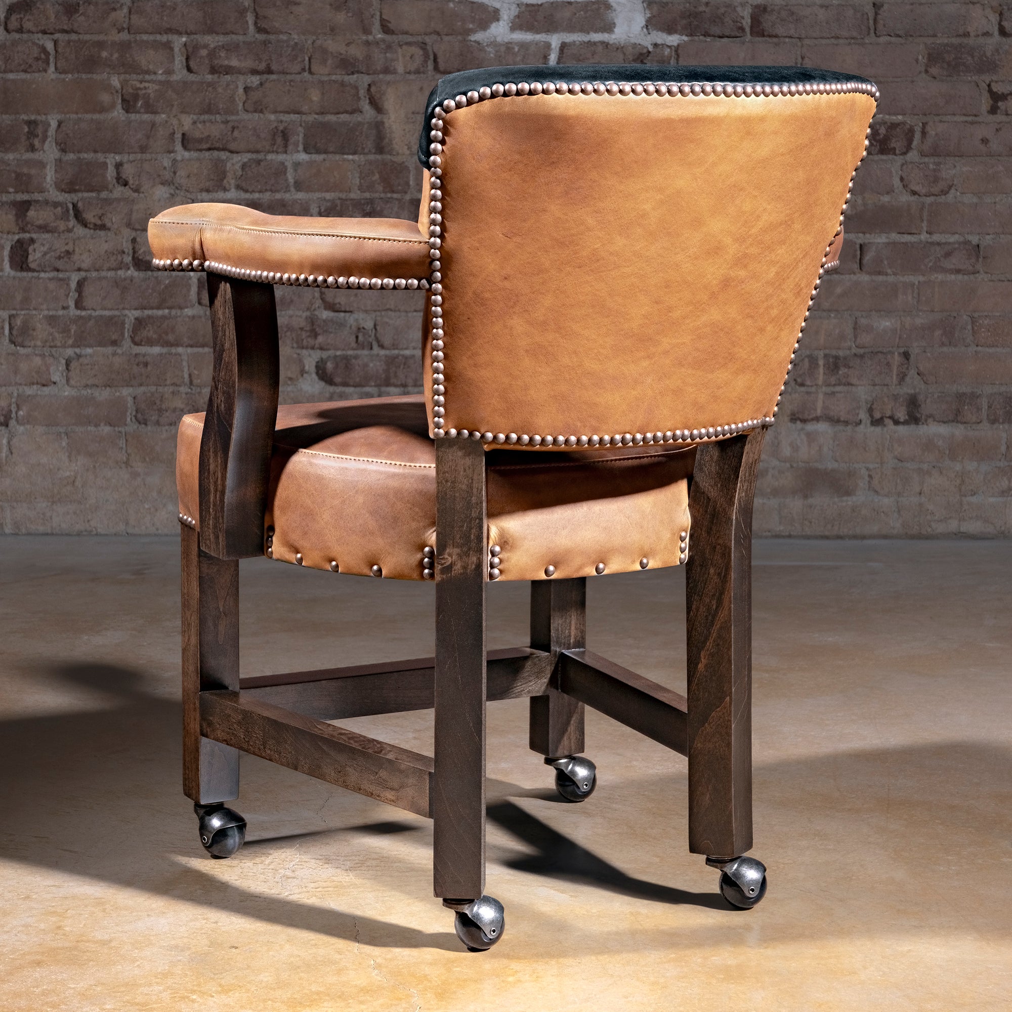 Presidio Dealer Chair western poker chair in tan top-grain leather with black yoke back, alder wood base, and casters