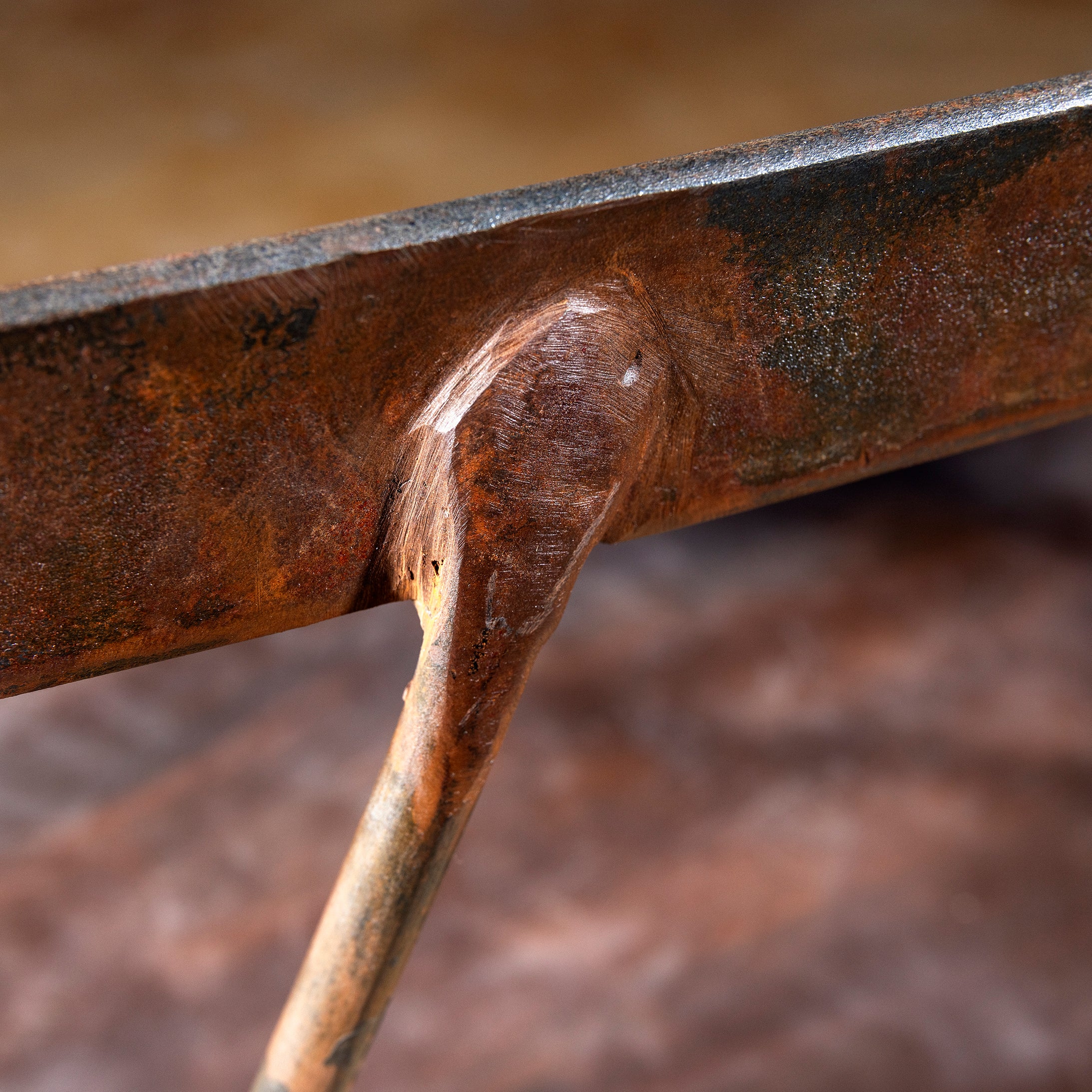 Closeup of hand forged iron joint detail on Railspur Gallery Western metal bench