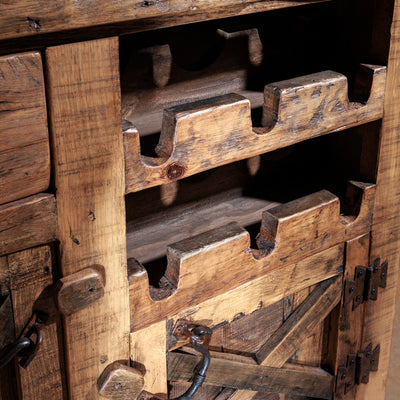Built-in six-bottle wine rack detail in reclaimed wood bar