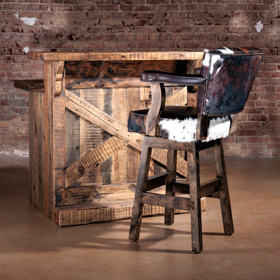 Rustic reclaimed wood bar paired with Western cowhide bar stool