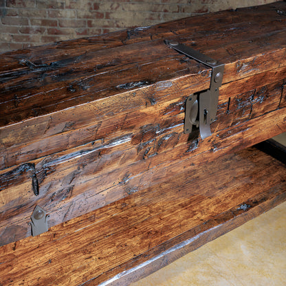 Close-up of handcrafted reclaimed wood grain and metal latch on rustic console