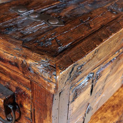 Detailed view of reclaimed wood texture and patina with iron strap hardware