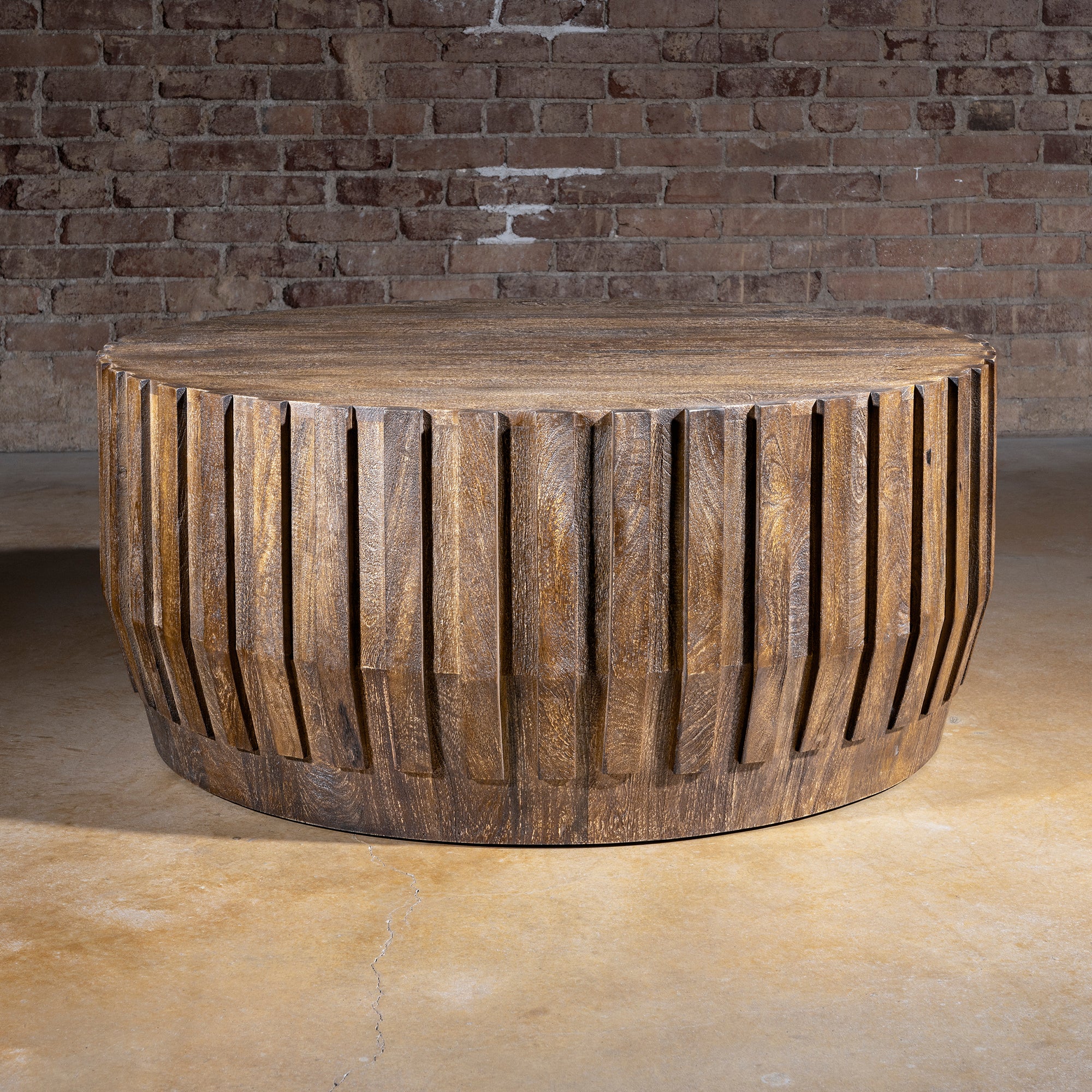 Ridgeline Drum Coffee Table western coffee table with carved fluted wood sides, round drum shape, and rustic lodge texture