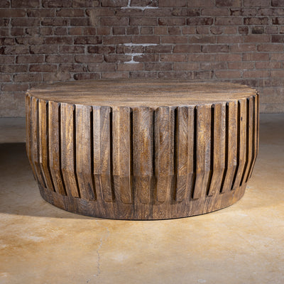 Ridgeline Drum Coffee Table western coffee table with carved fluted wood sides, round drum shape, and rustic lodge texture