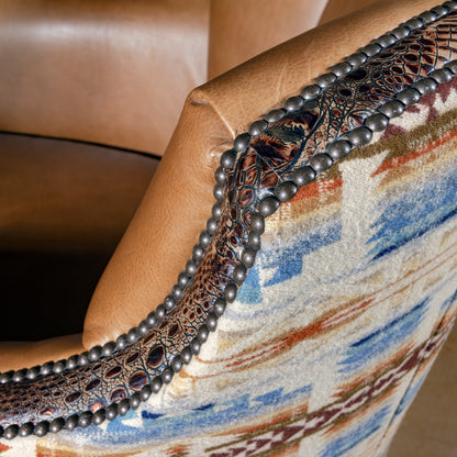 Embossed croc leather and nailhead trim framing Pendleton fabric on swivel chair