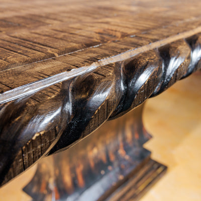 Detailed view of hand-carved rope trim on pub table