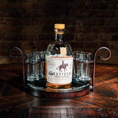 Shot glass tray shown with a bottle of whiskey