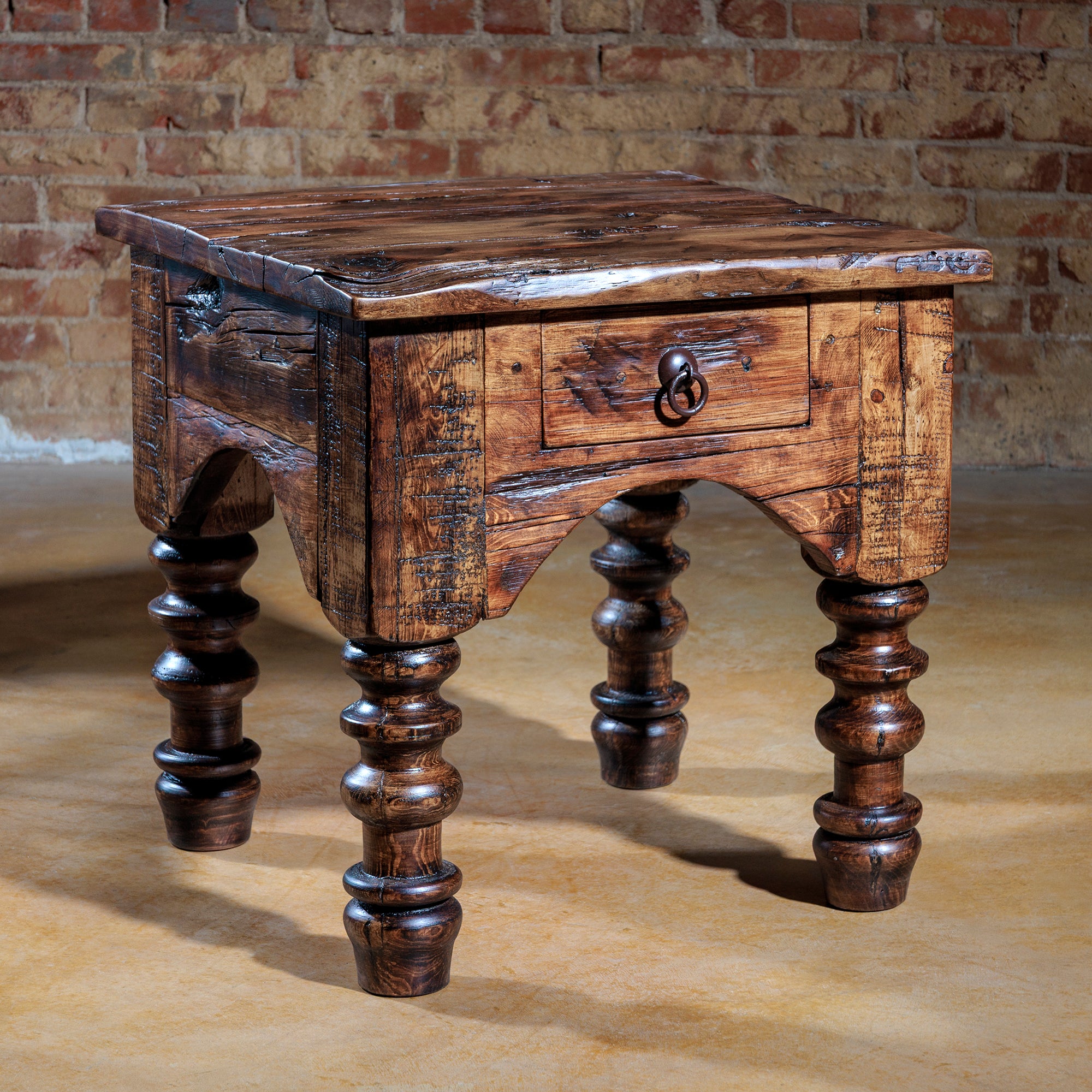 Rustic turned-leg accent table in Western setting with drawer closed