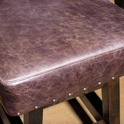 Sable Crest Hideback Bar Stool western cowhide bar stool seat detail with smooth brown leather cushion and handcrafted finish.