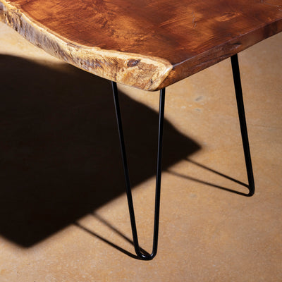 Closeup of iron hairpin legs on Sable Ridge live-edge walnut coffee table