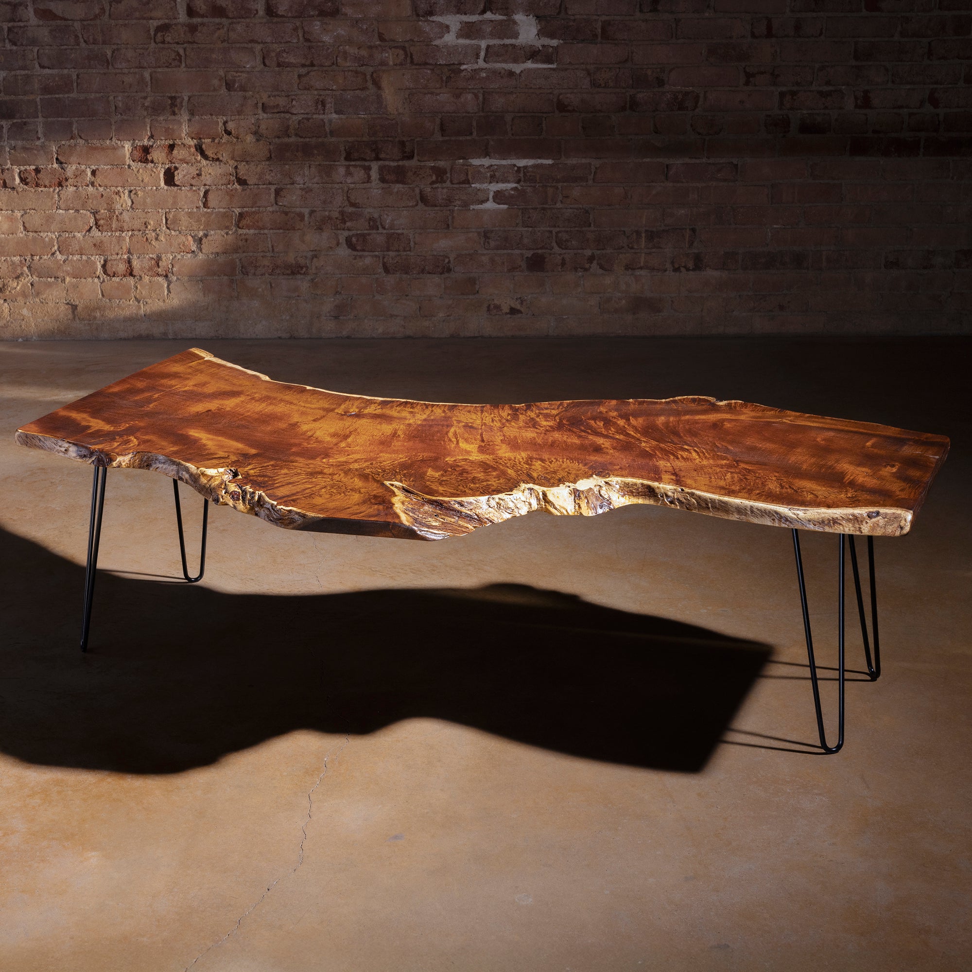 High-angle view showing dramatic walnut grain on Sable Ridge coffee table top