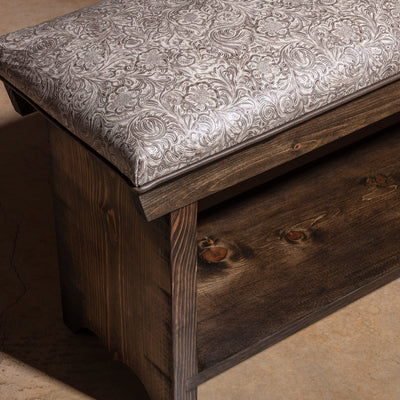 Saddle Bloom western bench corner detail with tooled leather cushion, dark stained wood frame, and handcrafted finish.