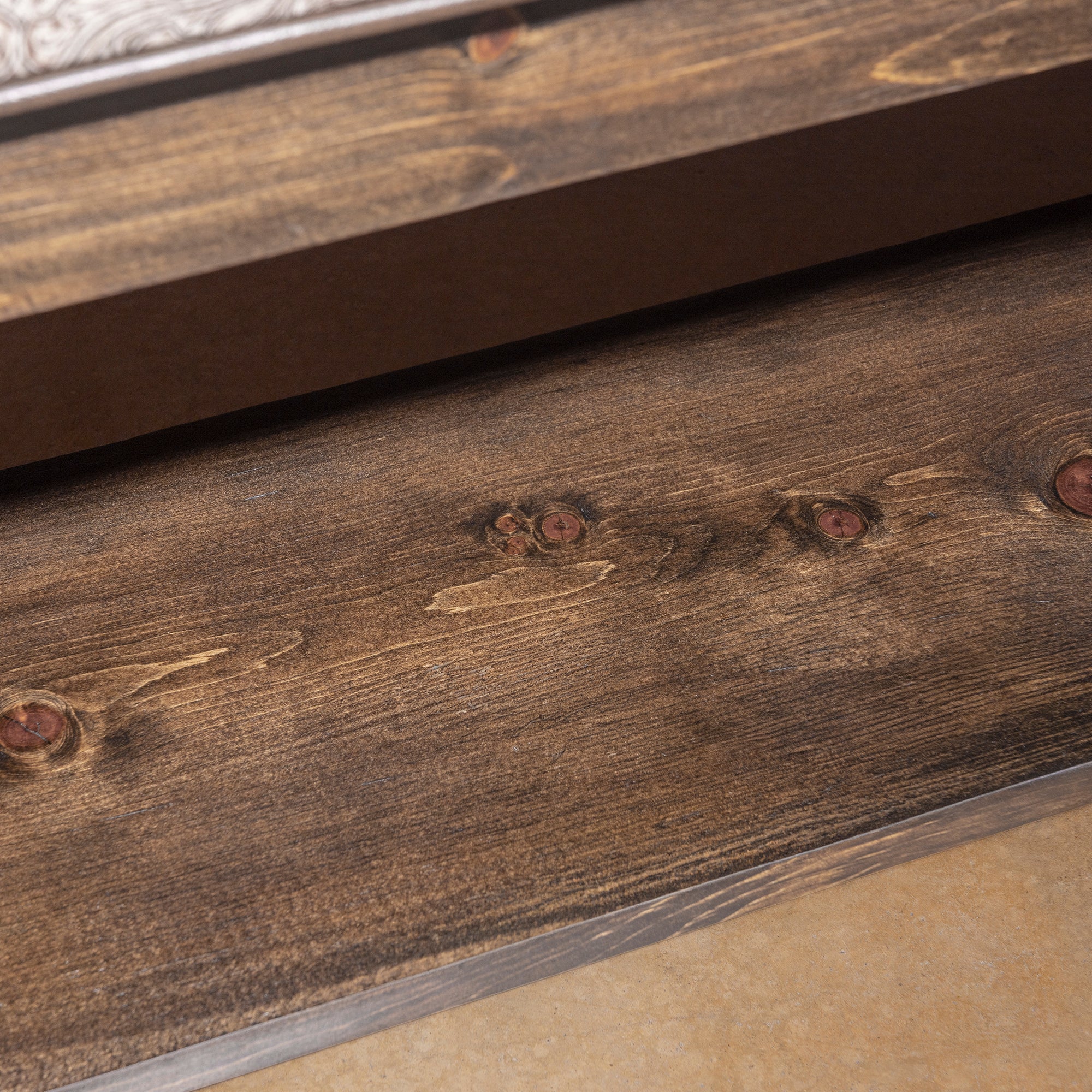 Saddle Bloom western bench lower shelf detail with solid wood construction and practical storage-ready open base.