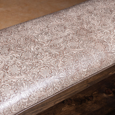 Saddle Bloom western bench with floral embossed leather seat detail and rich wood base for refined ranch interiors.