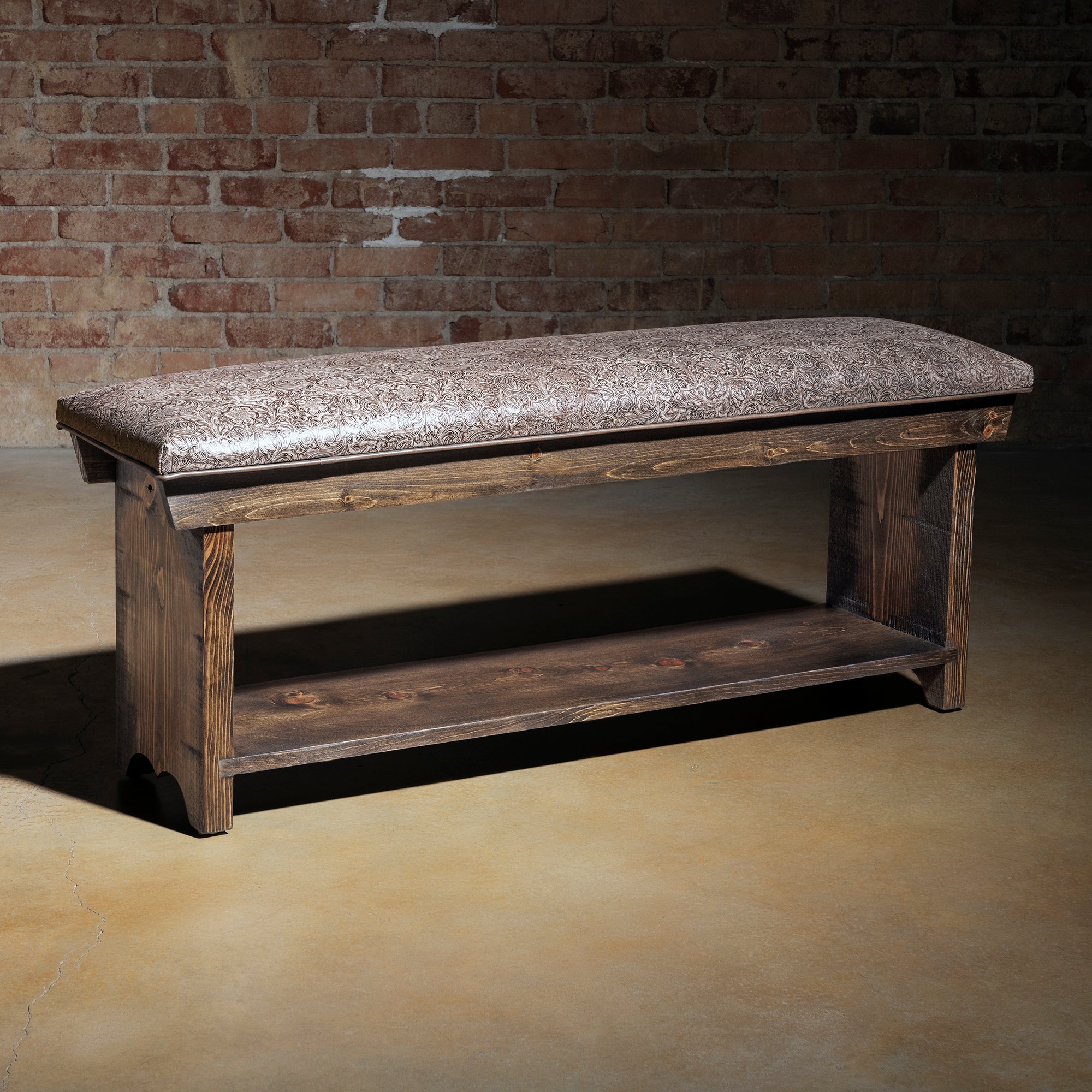 Saddle Bloom western bench full view with tooled top-grain leather cushion, long seat, and lower storage shelf.