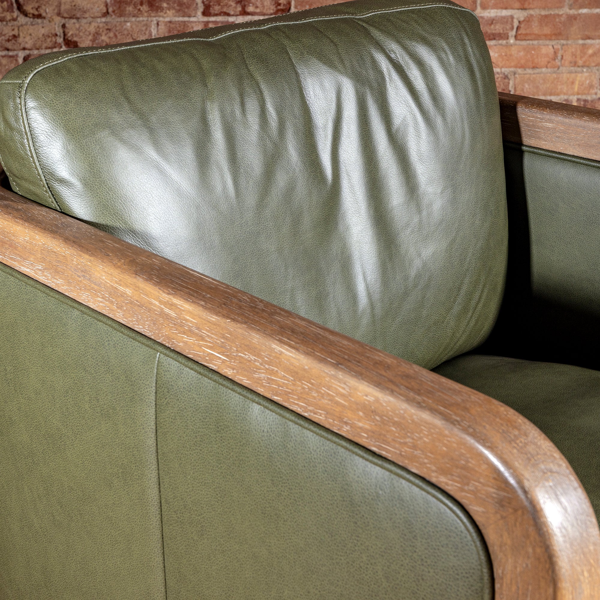 Sagewood Club Chair backrest detail with olive leather cushion and warm wood frame for modern Western interiors