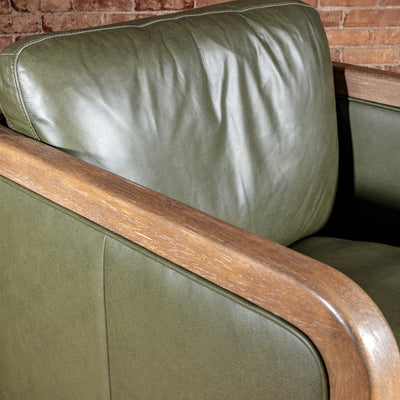 Sagewood Club Chair backrest detail with olive leather cushion and warm wood frame for modern Western interiors