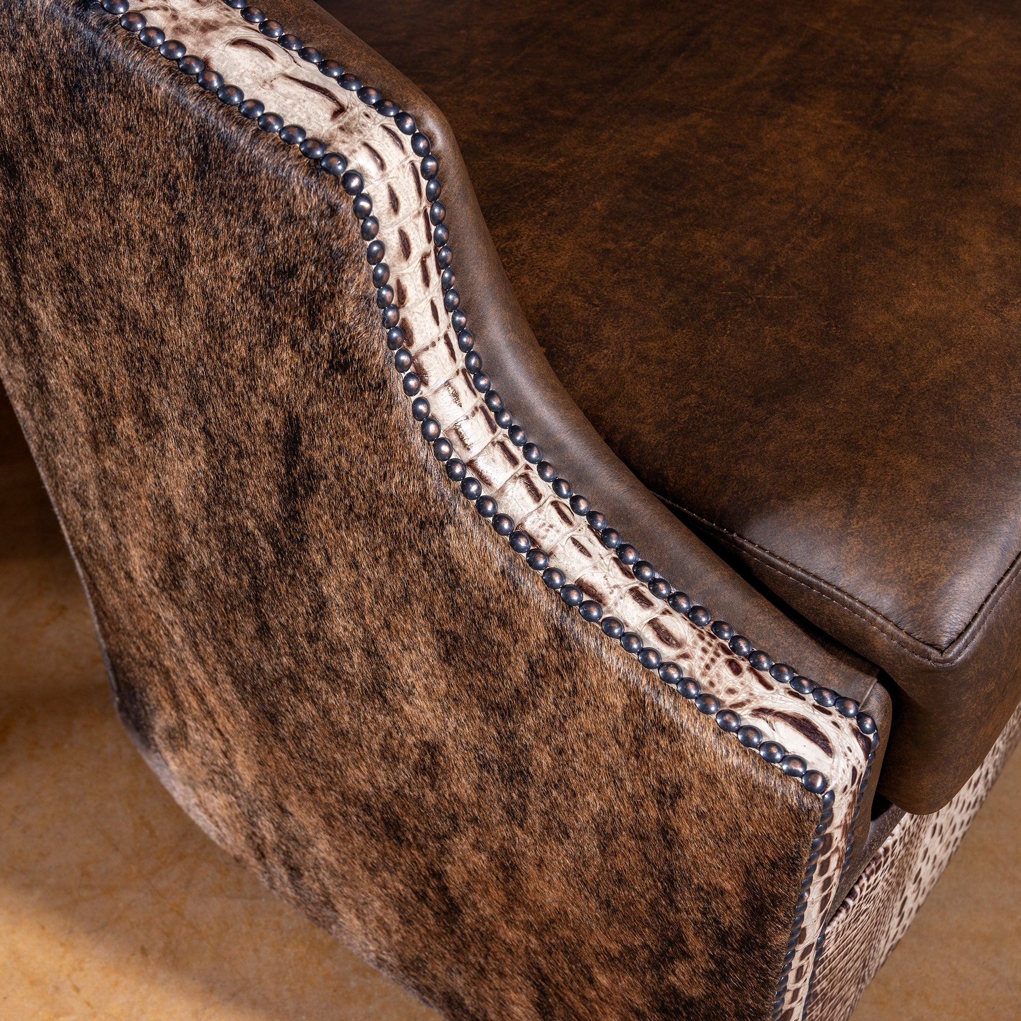 Croc leather and cowhide detail with antique nailhead trim on San Saba Bootstitch Swivel Chair