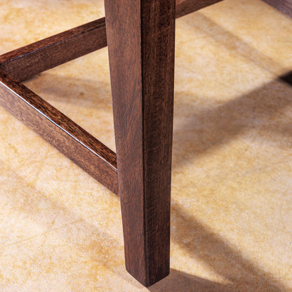 Detail of dark wood leg on handcrafted dining chair