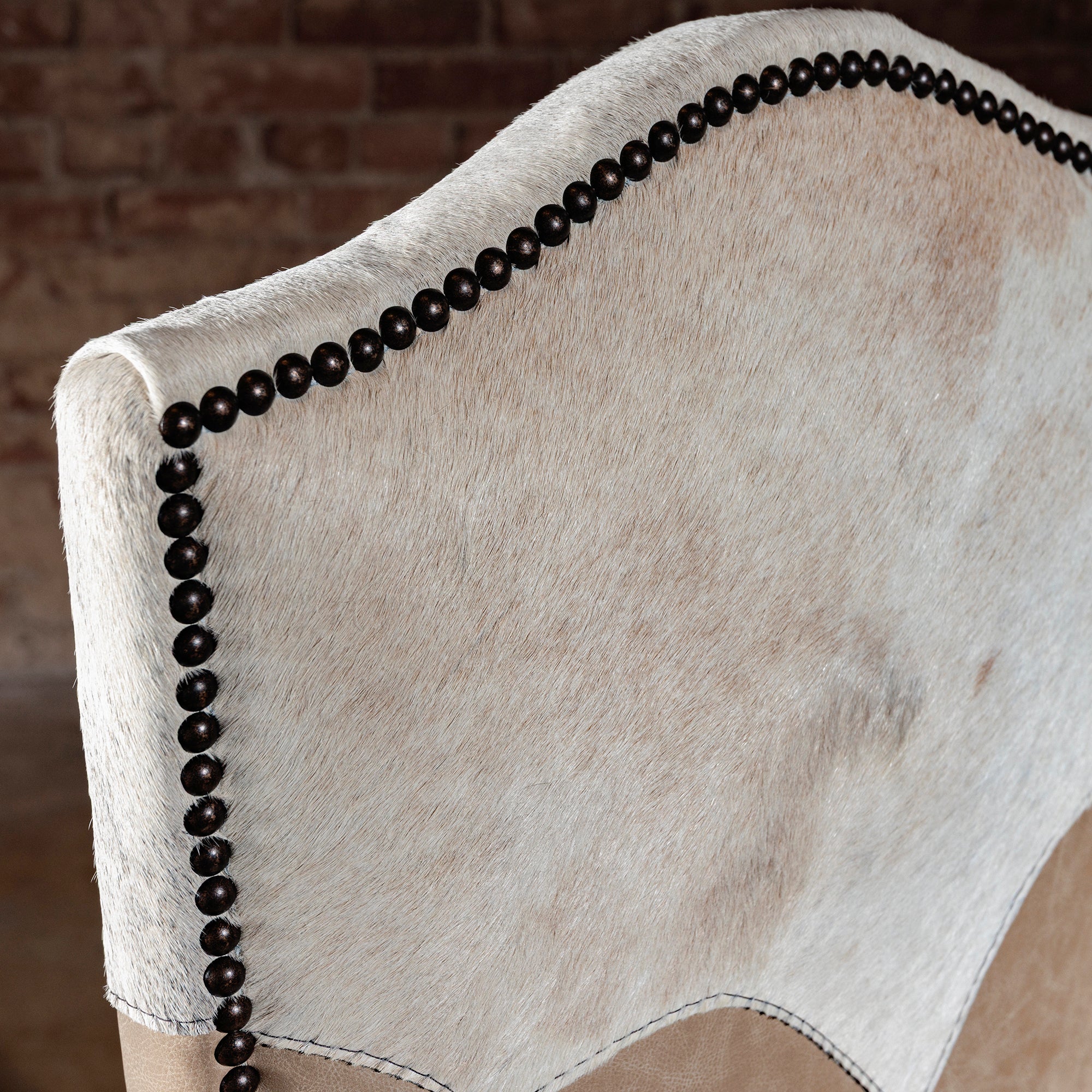 Close-up of pale cowhide yoke and nailhead trim on Santa Fe Yoke Dining Chair
