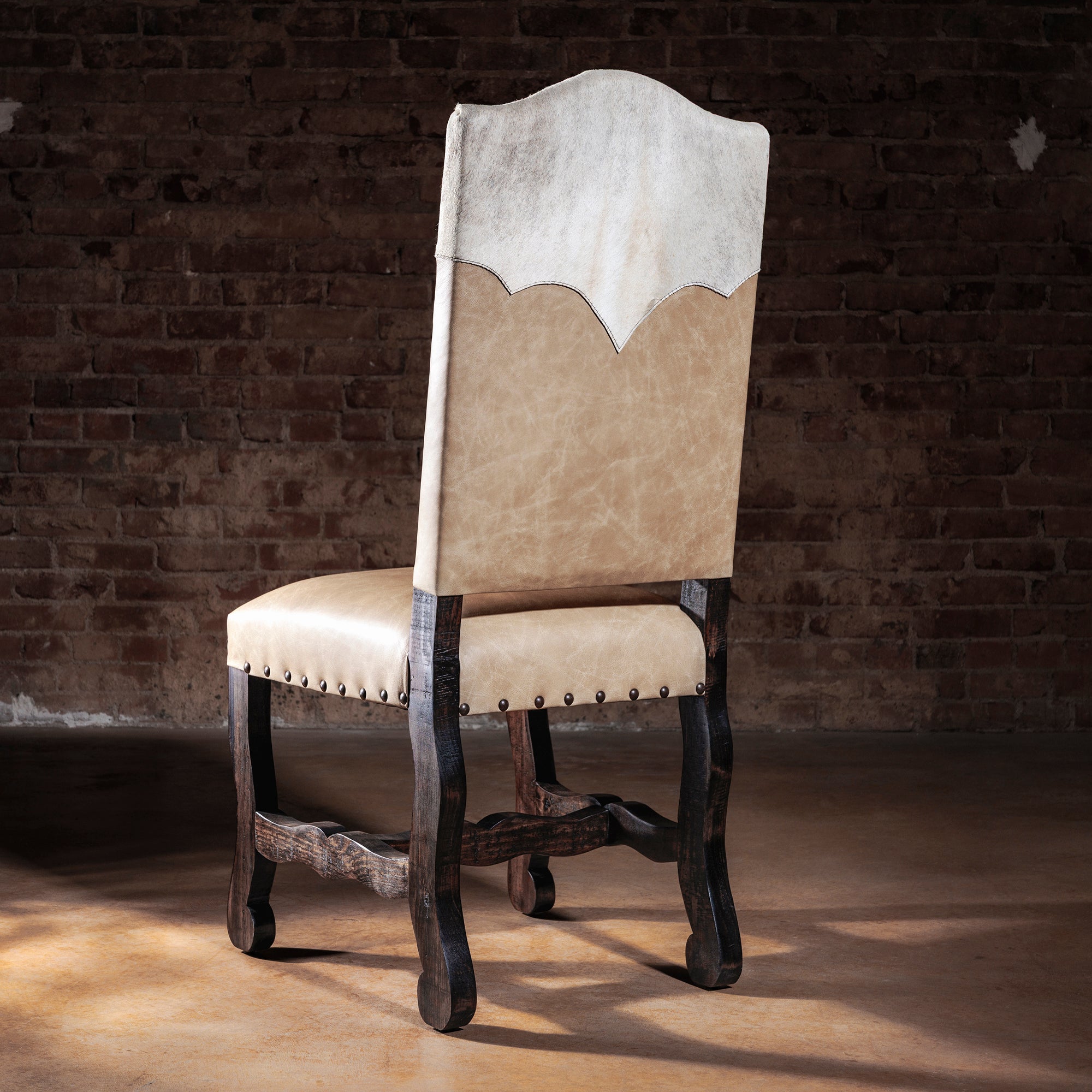 Back view of Santa Fe Yoke Dining Chair showing pale cowhide yoke panel, scalloped edge, and nailhead trim