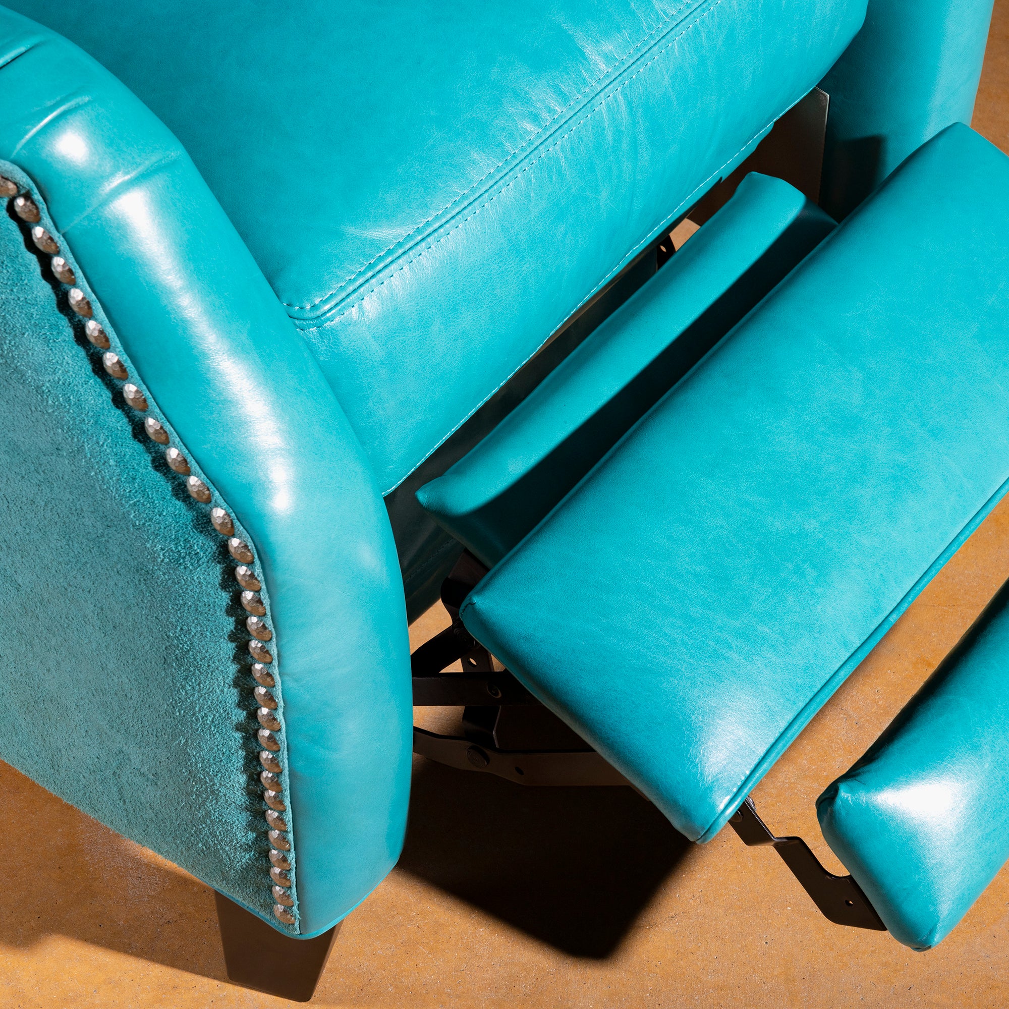 Premium turquoise top-grain leather detail on footrest