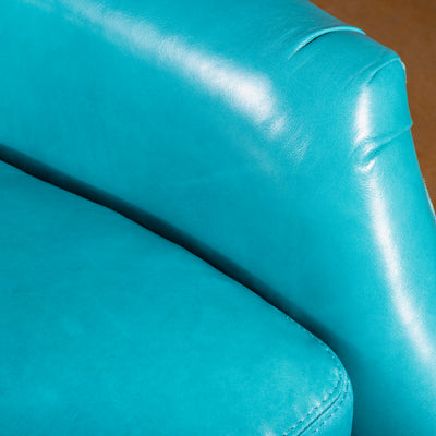 Premium turquoise top-grain leather detail on recliner arm