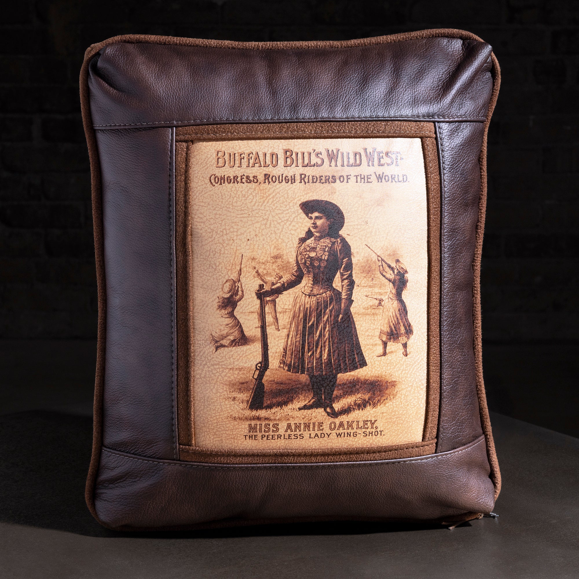 Showbill Sharpshooter Leather Western Throw Pillow western throw pillow with brown leather frame, vintage Wild West poster art, and suede trim