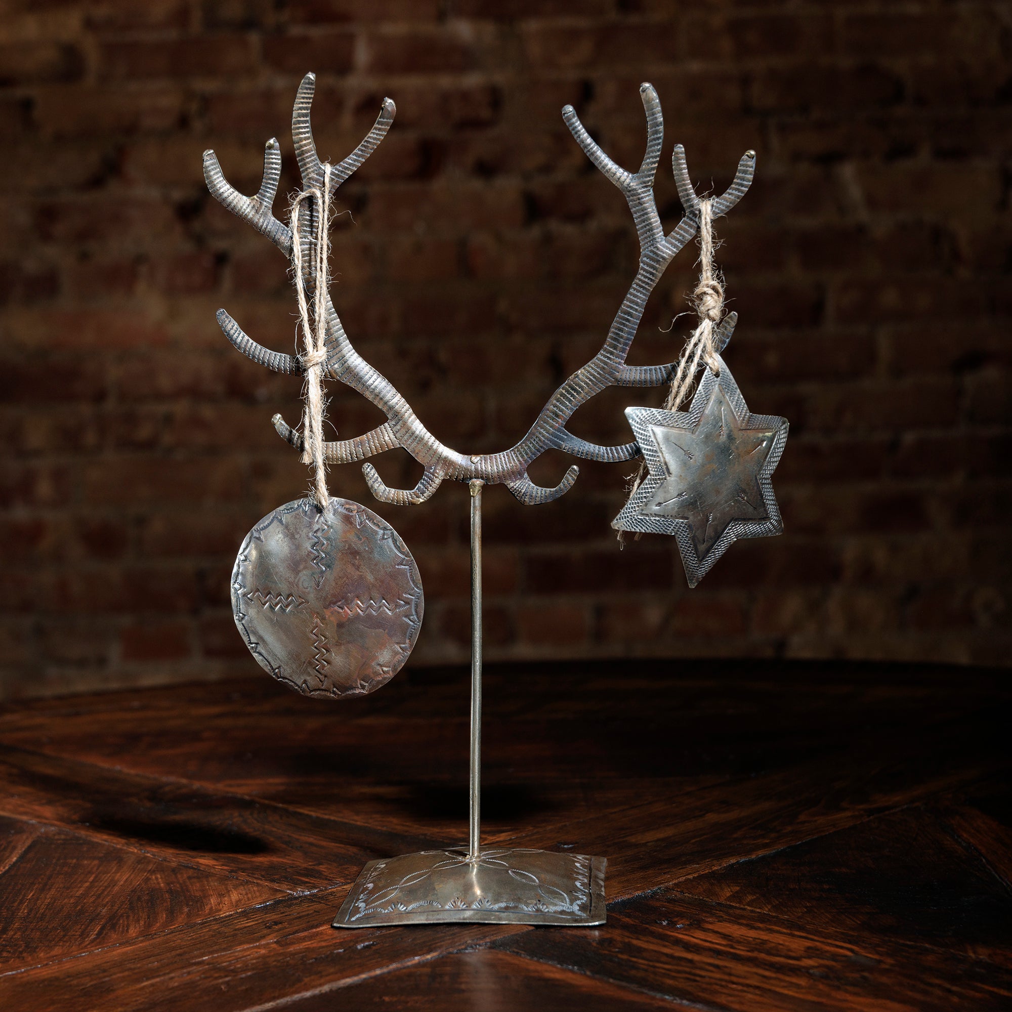 Silver antler-shaped tabletop tree with star and round metal ornaments