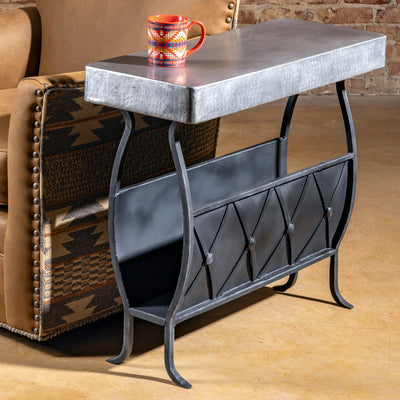 Sierra Forge Table with hammered silver metal top and forged iron base – styled beside Western chair