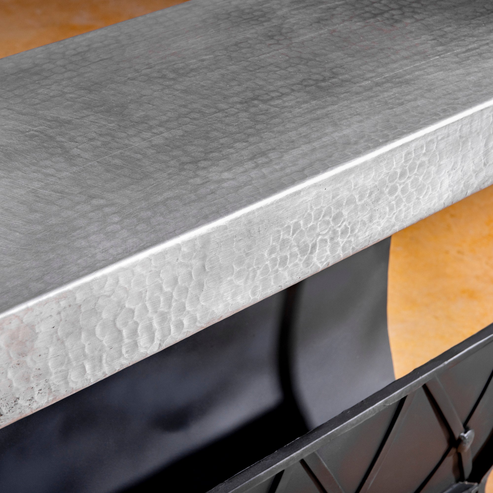 Side view of forged iron frame and riveted diamond-cross design