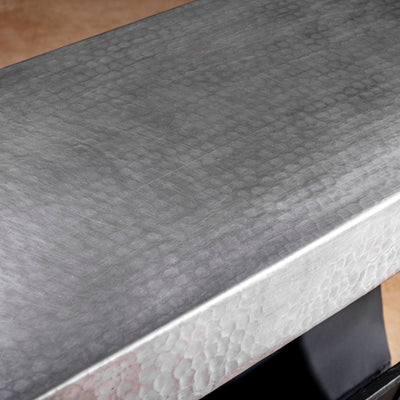 Close-up of hand-hammered metal surface on Sierra Forge Table