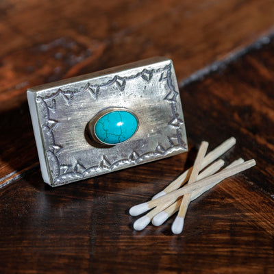 Hand-tooled silver matchbox case with turquoise emblem by J. Alexander