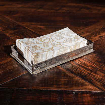 Western-style silver napkin holder by J. Alexander with printed paper napkins