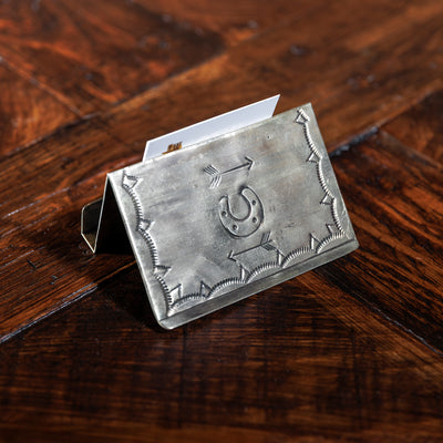 Back view of silver card holder with horseshoe and arrow stamp pattern