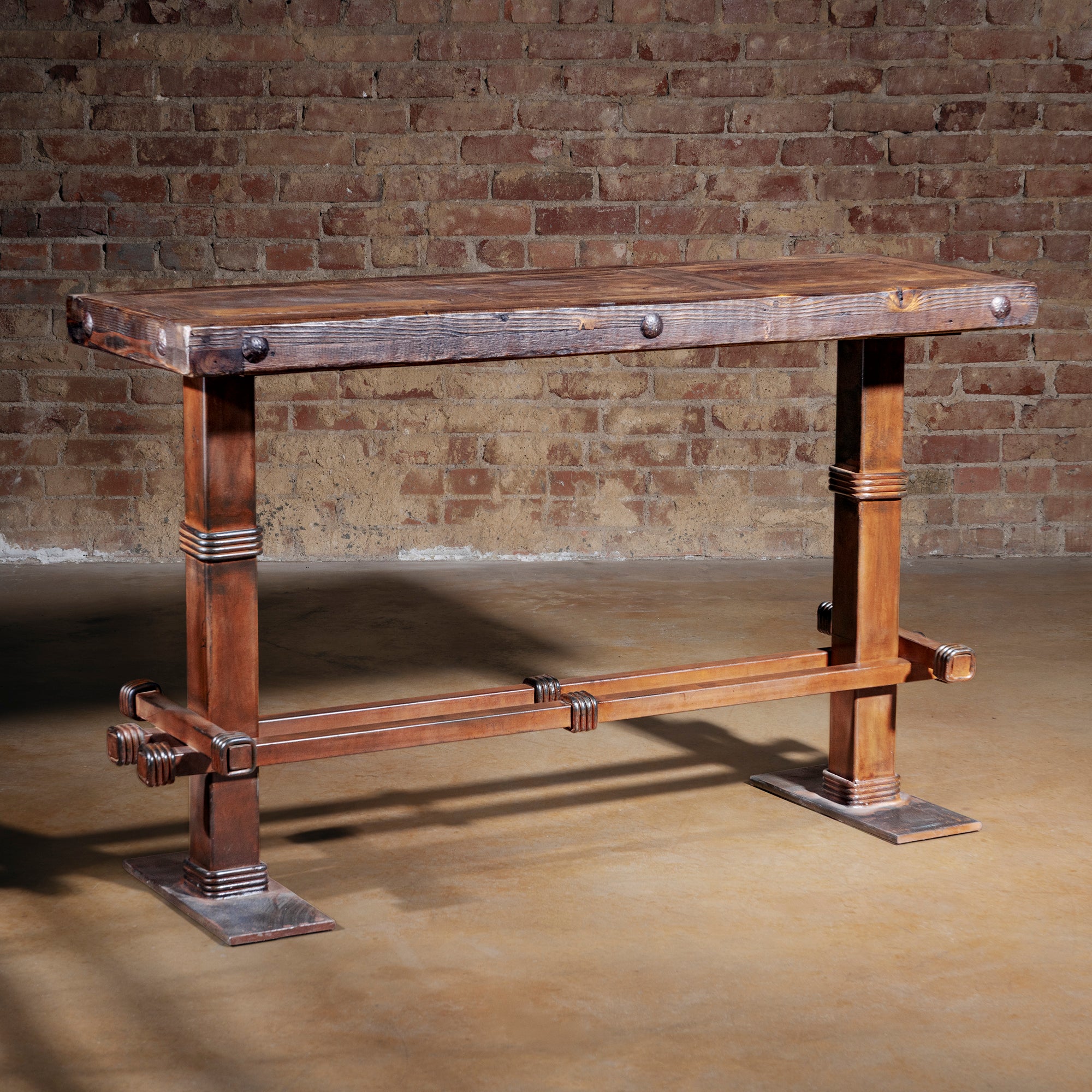 Spur Line Iron Console Table at three quarter angle showcasing reclaimed wood top and Western iron base
