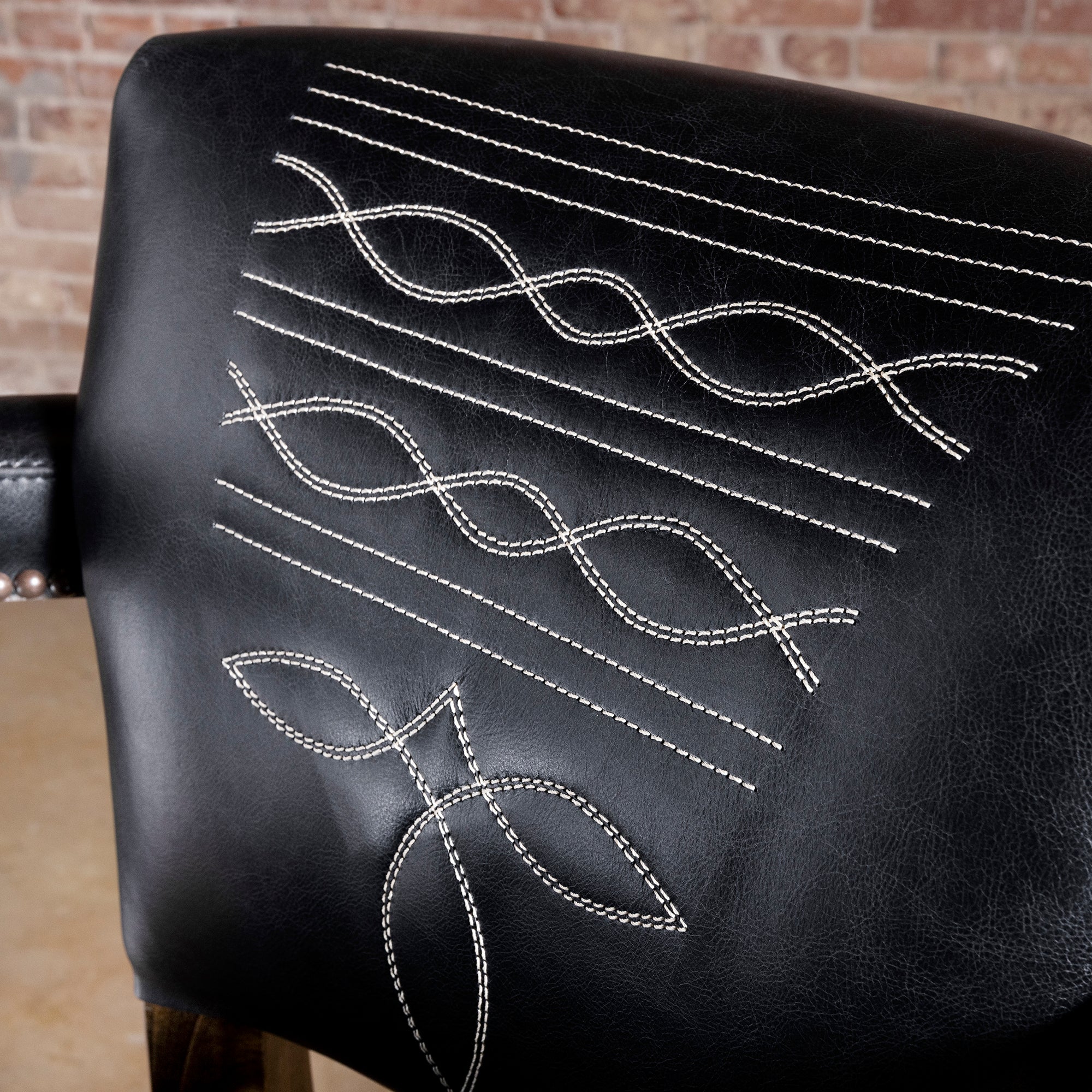 Stallion Grove Bar Stool western axis hide bar stool closeup showing black leather backrest with contrast bootstitch embroidery and refined Western lines