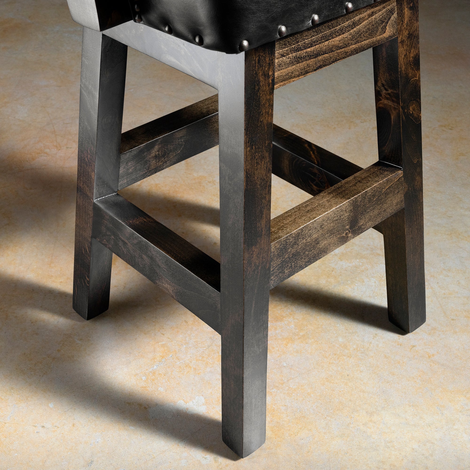 Stallion Grove Bar Stool western axis hide bar stool frame detail with alderwood legs, stretcher support, and handcrafted ranch-ready construction