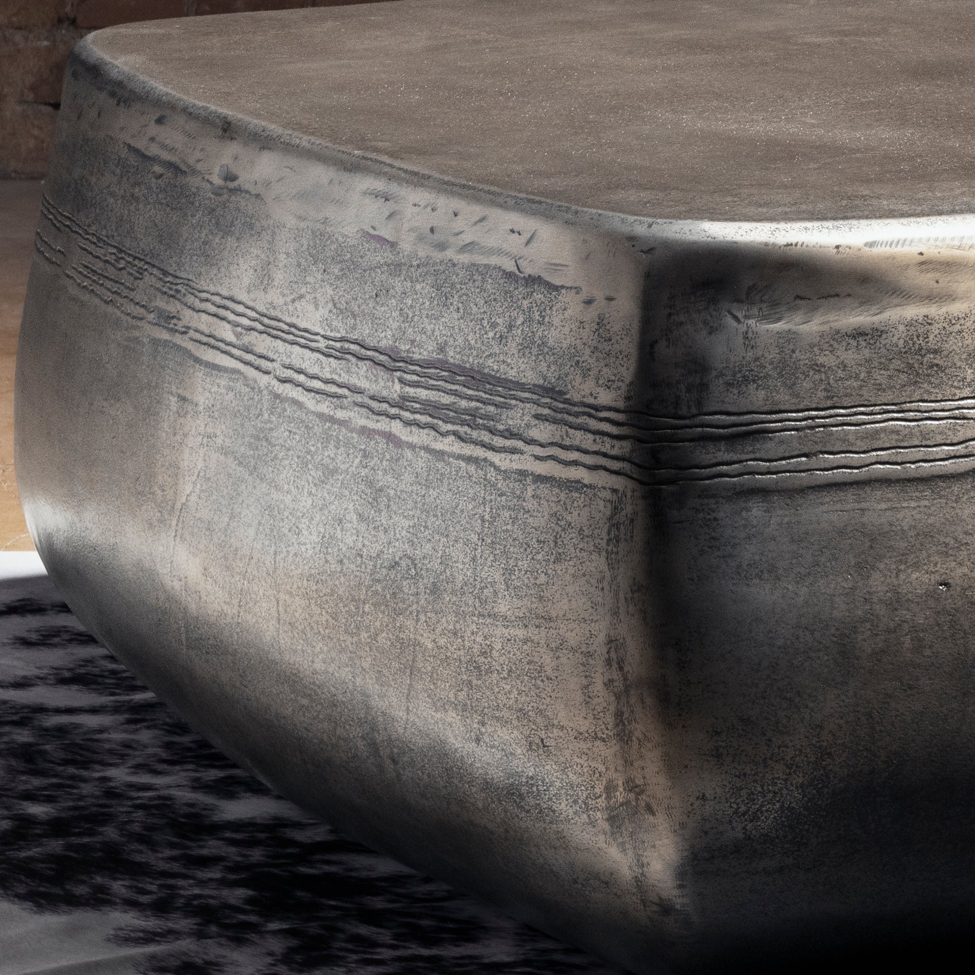 Sterling Range Forge Low Western Metal Coffee Table western coffee table close-up with hand-worked top texture and burnished metal edge.