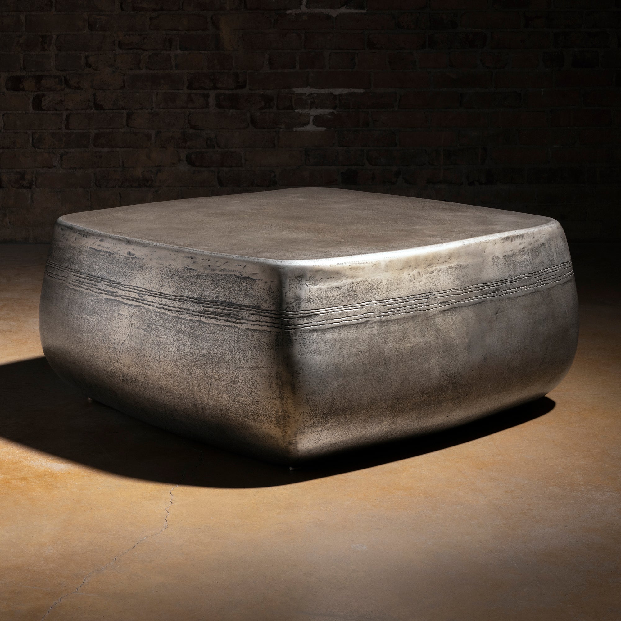 Sterling Range Forge Low Western Metal Coffee Table western coffee table with a low sculptural form, softened corners, and silver finish.
