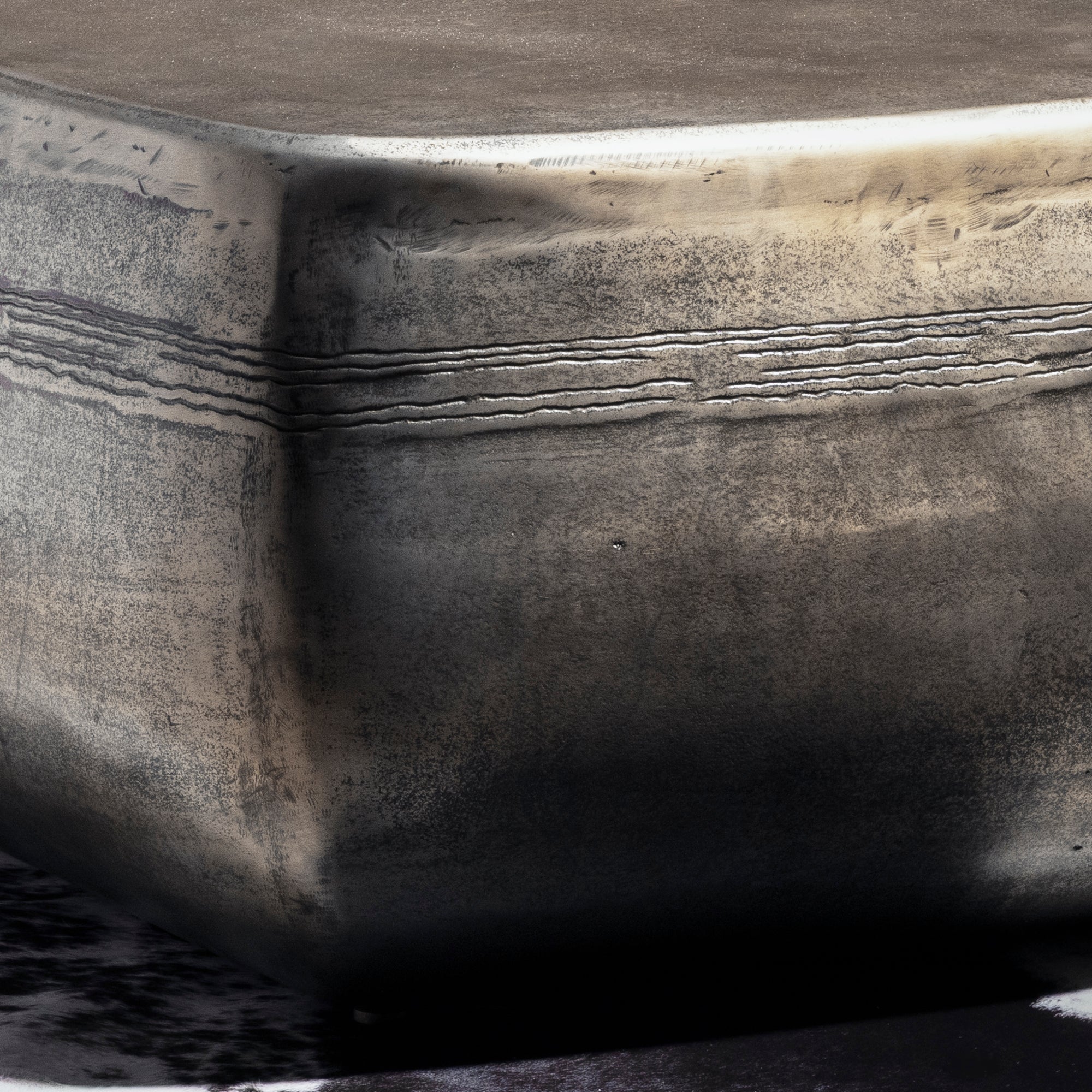 Sterling Range Forge Low Western Metal Coffee Table western coffee table with a low sculptural form, softened corners, and silver finish.