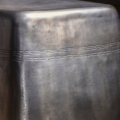 Sterling Spur Accent Table close-up of the silver metal accent table showing hand-textured finish, softened corners, and forged band detail