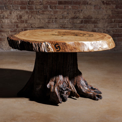Moody lighting view of Sundermill Rootstone Table live-edge Western coffee table