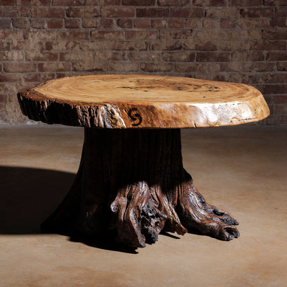 Moody lighting view of Sundermill Rootstone Table live-edge Western coffee table