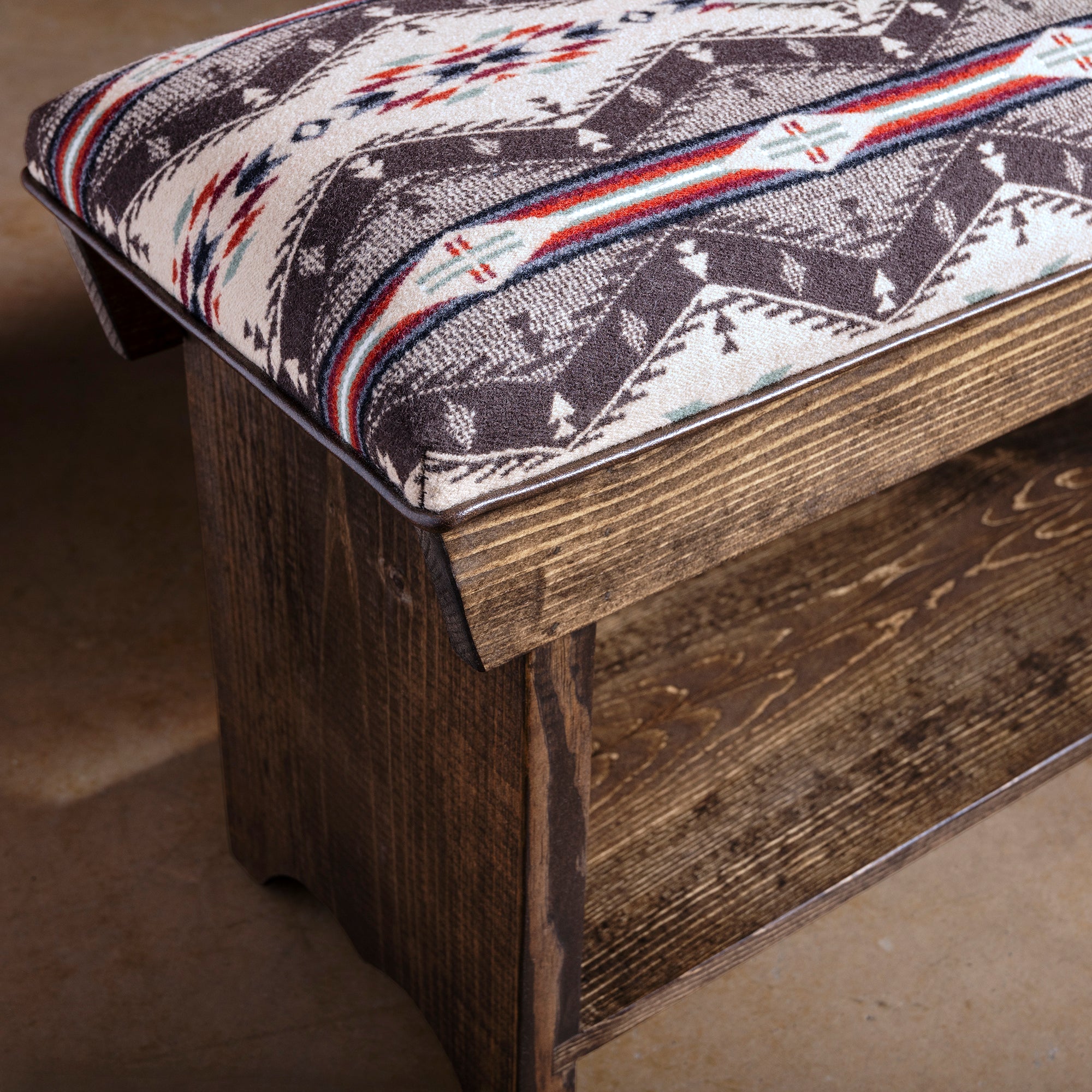 Sundown Loom Upholstered Western Ranch Bench western bench close-up with dark wood corner, upholstered cushion, and lower shelf detail