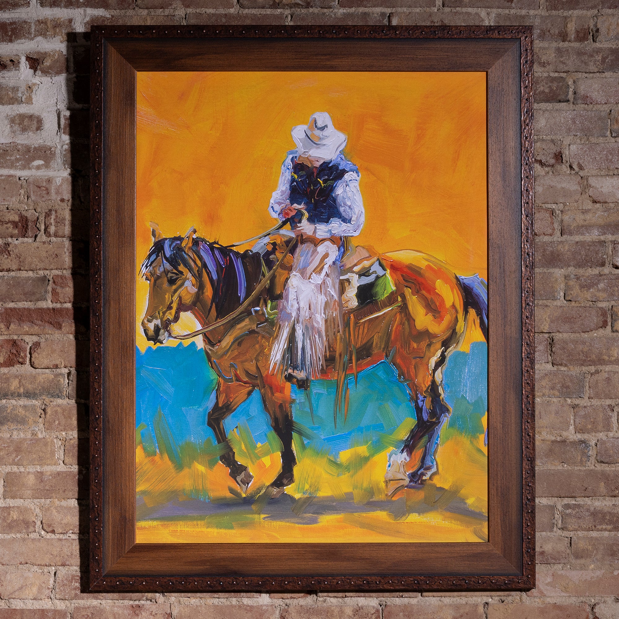 Sunfire Vaquero Framed Western Cowboy Wall Art western wall art with a painterly rider on horseback, vivid orange sky, and dark wood frame