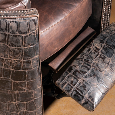Recliner footrest extended showing croc hide upholstery and steel frame – Into The West