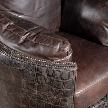 Nailhead trim detail framing croc hide and leather armrest – Into The West